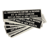 Sticker "La Différence Entre un Homme et un Petit Garçon est le Prix de ses Jouets". Text in french. Unit.